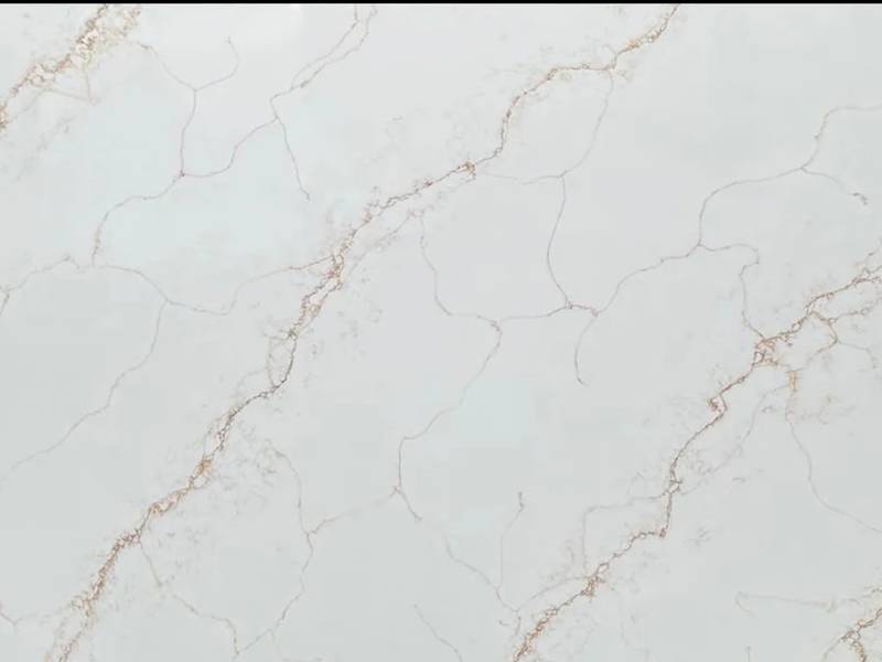 Calacatta Gold quartz surface with white background and grey gold veining